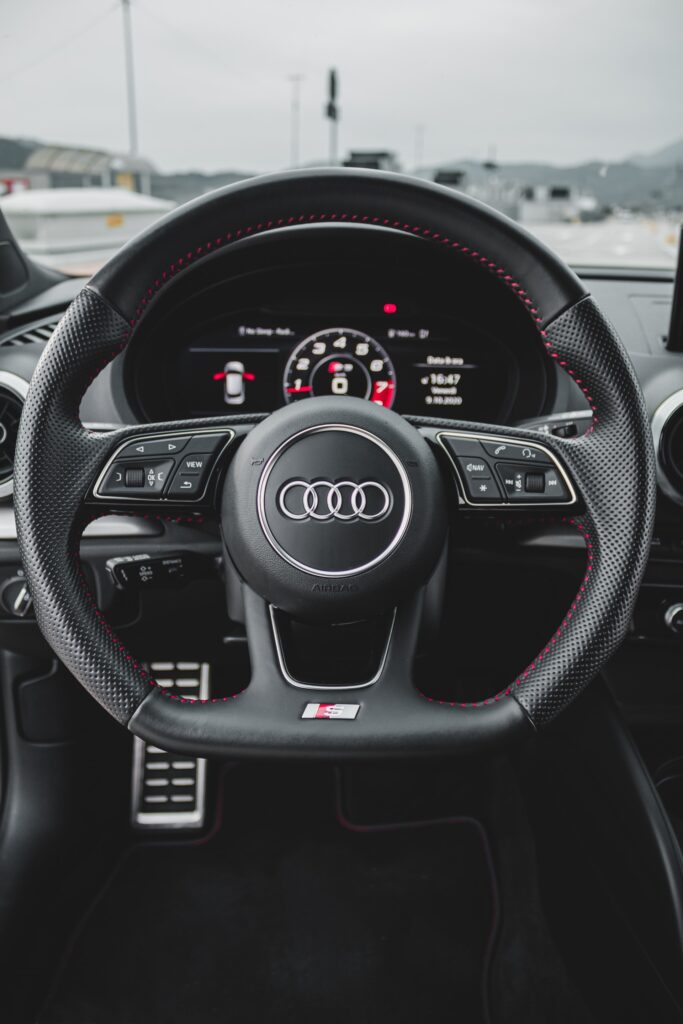inside of an Audi, steering wheel and dashboard,